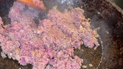 Meat with rice is cooked in the pan Stock Footage 221271998