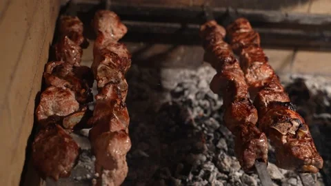 Meat is roasted on a fire. Delicious roasted pieces of meat on coalsGrill roast Stock Footage 174810720