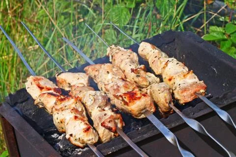Meat is roasted on skewers Stock Photos