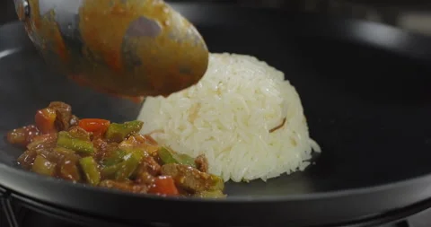 Meat roasted with vegetables. Chef puts dish on an iron plate. Lamb vegetables Stock Footage 277657993
