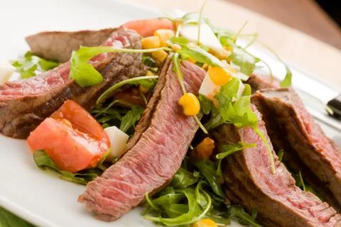 Meat with rocket salad Stock Photos