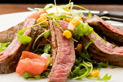 Meat with rocket salad Stock Photos