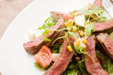 Meat with rocket salad Stock Photos