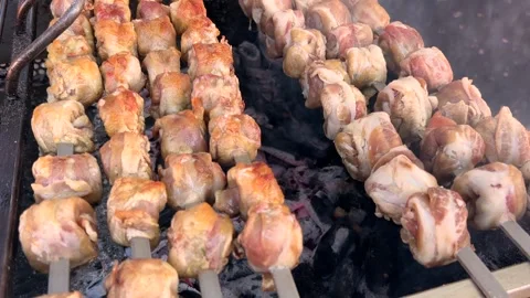 Meat rolls wrapped in bacon skewered and grilled over an open flame Stock Footage 330749788