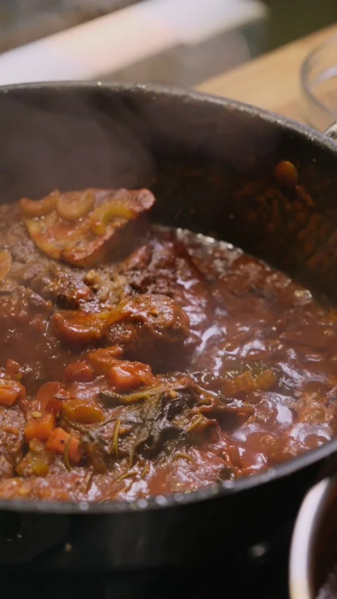 Meat in sauce boiling in a saucepan Stock Footage 305305767