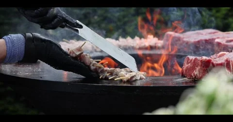 Meat sizzling on an open flame grill during a barbecue cookout. Stock Footage 311673449