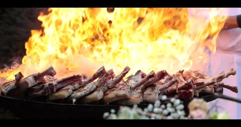 Meat sizzling on an open flame grill during a barbecue cookout. Stock Footage 311673463