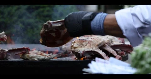 Meat sizzling on an open flame grill during a barbecue cookout. Stock Footage 311673481