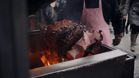 Meat skewer roasted on fire, big piece of pork traditional czech prague Stock Footage 122512002