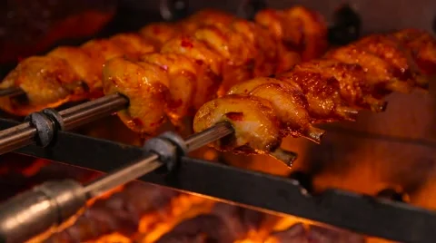 Meat on skewer roasting on the fire Stock Footage 64830048