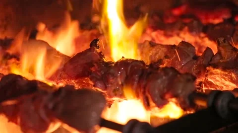 Meat on skewer roasting on the fire Stock Footage 64830104