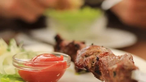 Meat skewers on the dinner table Stock Footage 111441421
