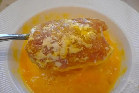 Meat slice dipped in egg for frying Stock Photos