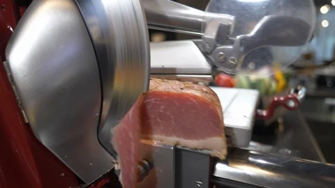 Meat slicer cutting to slices Stock Footage 99401340