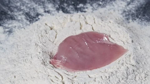 The meat is slowly falling into the flour. Stock Footage 140182460