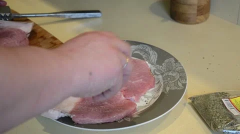 Meat sousing and preparing for baking. hand put salt on food Stock Footage 20478984