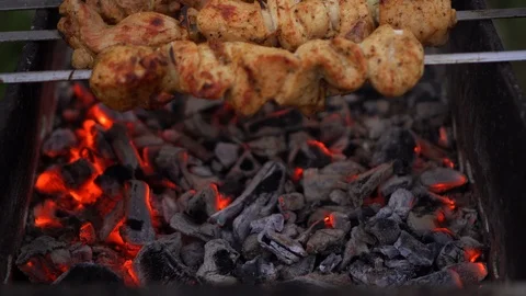 Meat on spit is baked on grill Stock Footage 93668997