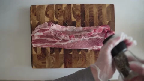 The meat is sprinkled with black pepper Stock Footage 169834944
