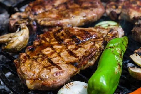 Meat steak on grill Stock Photos