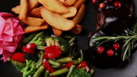 Meat steak with potatoes and vegetables on a plate Stock Footage 328186779