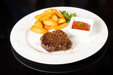Meat  steak with potatoes Stock Photos