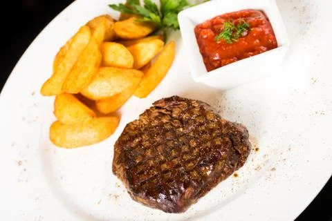 Meat  steak with potatoes Stock Photos
