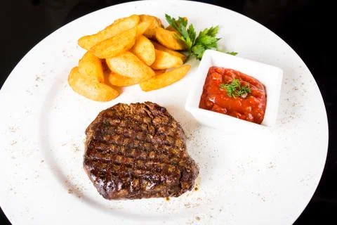 Meat  steak with potatoes Stock Photos