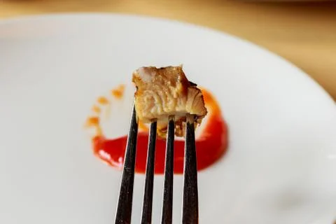 Meat steak stab in fork dipping spicy sauce Stock Photos