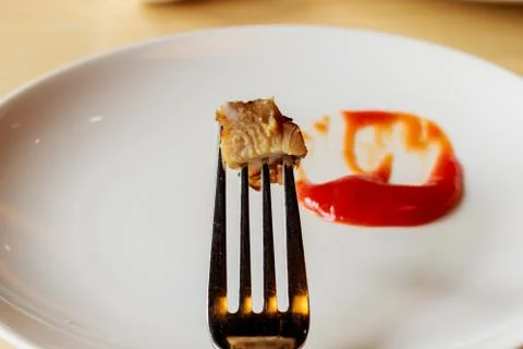 Meat steak stab in fork dipping spicy sauce Stock Photos
