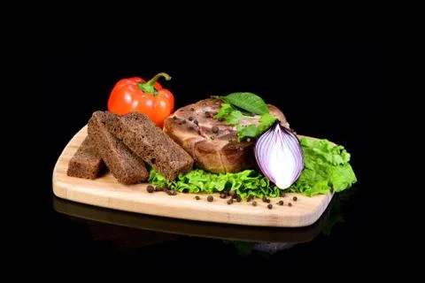 Meat steak with vegetables on a breadboard Stock Photos