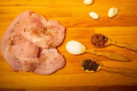 Meat steaks and various spices on a wooden Board. Close up. Stock Photos