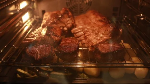 Meat steaks is baked in the oven Stock Footage 113016735