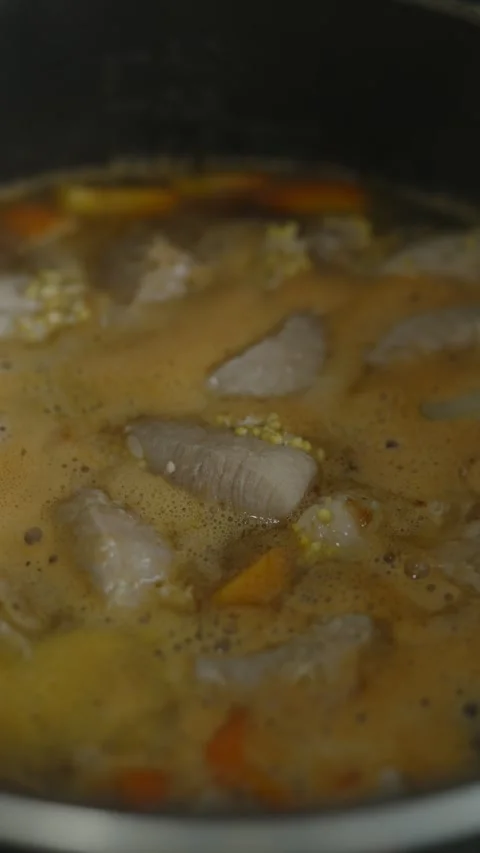 Meat stew with vegetables and grains simmering in multi-cooker Stock Footage 335392110
