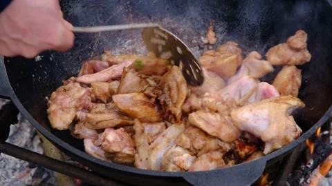 The meat is stewed in a cauldron. Chicken meat is stewed in a cauldron. A dish Stock Footage 280213901