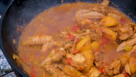 The meat is stewed in a cauldron. Chicken meat is stewed in a cauldron. A dish o Stock Footage 282829423