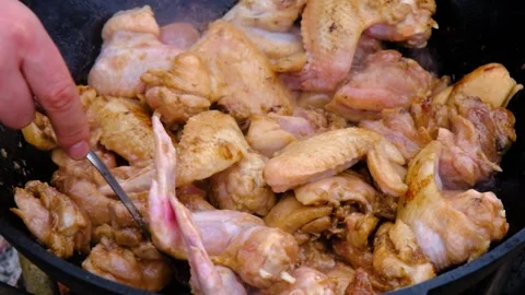 The meat is stewed in a cauldron. Chicken meat is stewed in a cauldron. A dish o Stock Footage 282829510