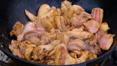 The meat is stewed in a cauldron. Chicken meat is stewed in a cauldron. A dish o Stock Footage 283629520