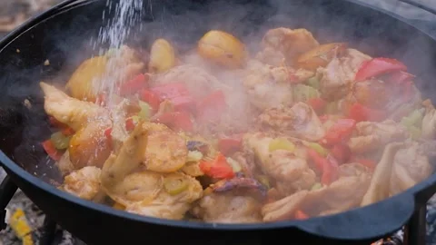 The meat is stewed in a cauldron. Chicken meat is stewed in a cauldron. A dish o Stock Footage 283629902
