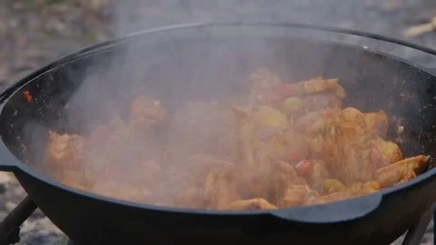 The meat is stewed in a cauldron. Chicken meat is stewed in a cauldron. A dish Stock Footage 307313987