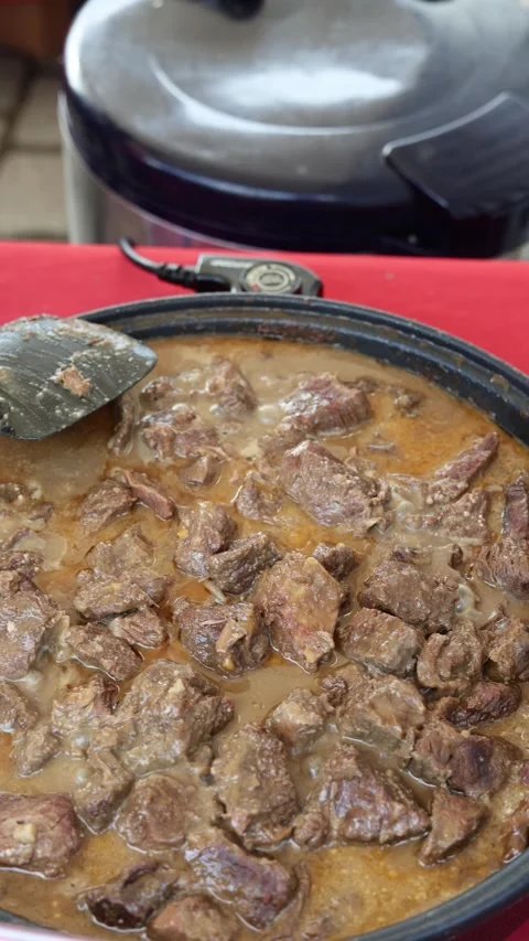 Meat stewing in a frying pan vertical video Stock Footage 287119402