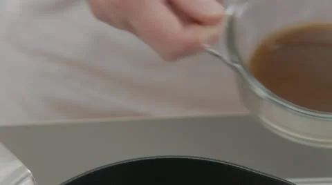 Meat stock being poured into a pot Stock Footage 24650653