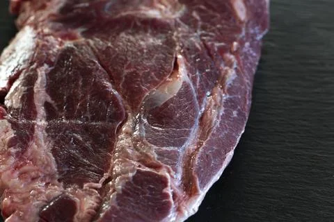 Meat texture, raw steak close up, Ribeye on black background Stock Photos