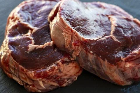 Meat texture, raw steak close up, Ribeye on black background Stock Photos