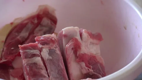 Meat with a thick layer of bacon lies on the table in a basin Stock Footage 148087763