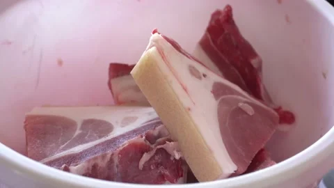 Meat with a thick layer of bacon lies on the table in a basin Stock Footage 148127132