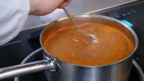 Meat in tomato sauce in a boiling pan. Chef is cooking goulash. Stock Footage 107192068