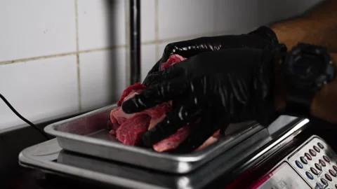 Meat is weighed on a scale Stock Footage 168886084