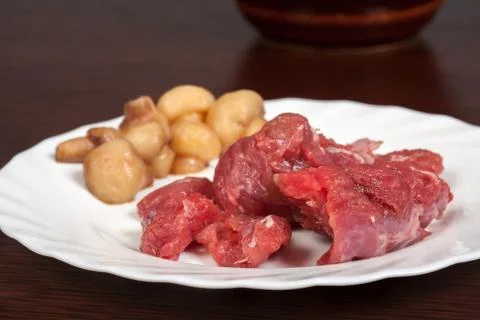Meat on a white plate on the table Stock Photos