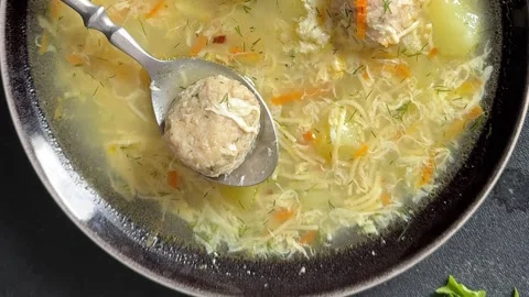 Meatball soup, egg, vegetables, meat first course lunch or dinner tasty food Stock Footage 335654834