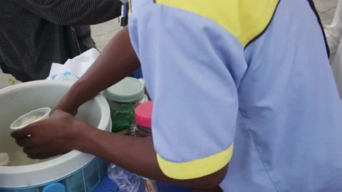 Meatball vendor preparing cold drinks for customers Stock Footage 220703615